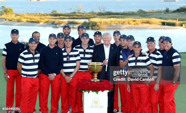 President Donald Trump poses with the victorious United States team led by Steve Stricker after their 19-11 win during the final day singles matches...