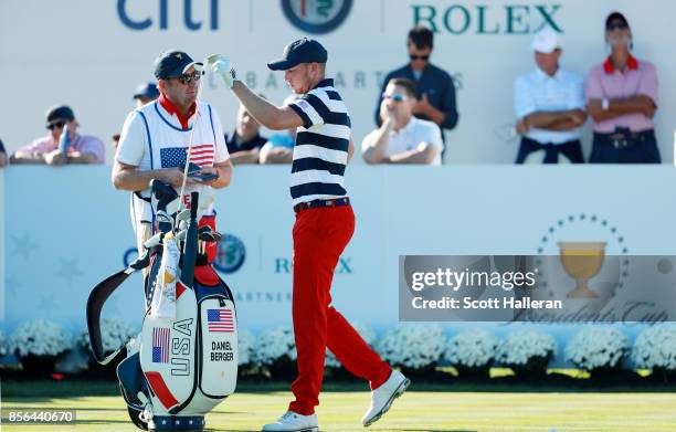 Daniel Berger of the U.S. Team and his caddie Grant Berry prepare to tee off during the Sunday singles matches at the Presidents Cup at Liberty...