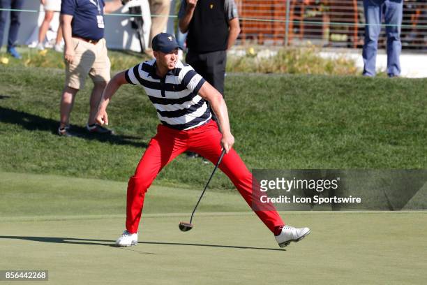 Golfer Daniel Berger reacts to making a birdie putt on the 14th hole during the final round of the Presidents Cup at Liberty National Golf Club on...