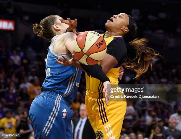 Odyssey Sims of the Los Angeles Sparks is fouled by guard Lindsay Whalen of the Minnesota Lynx as she goes for a layup during first quarter of Game...