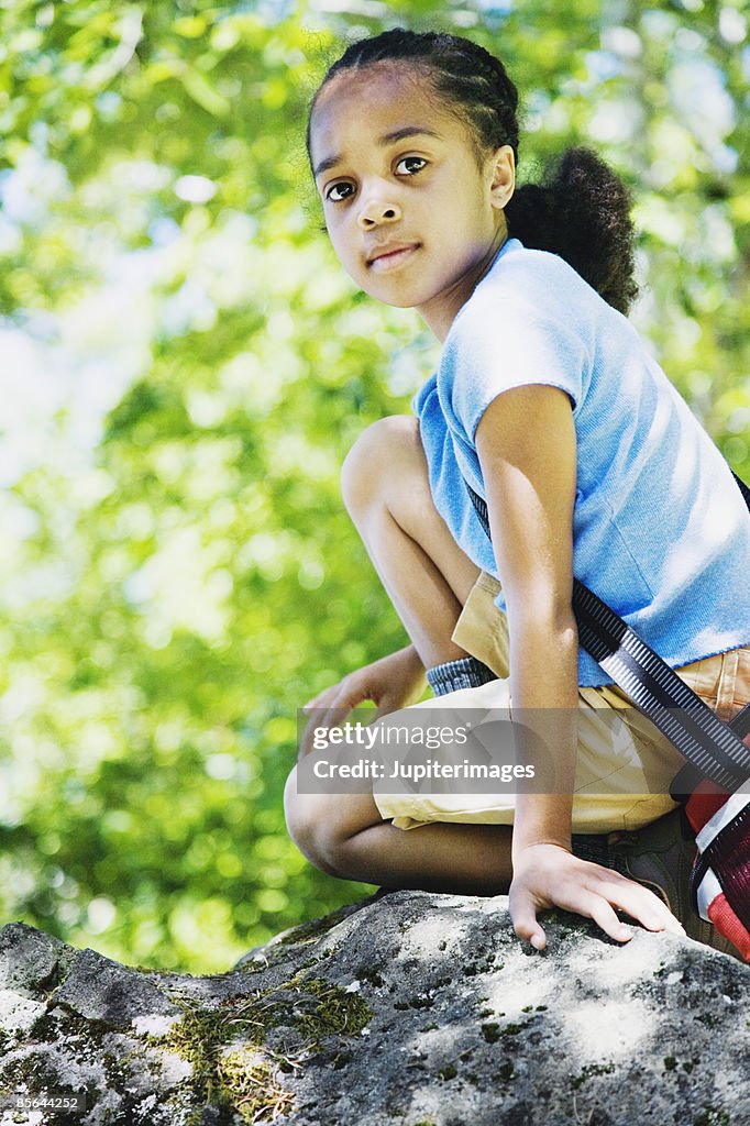 Girl Kneeling On Rock High-Res Stock Photo - Getty Images