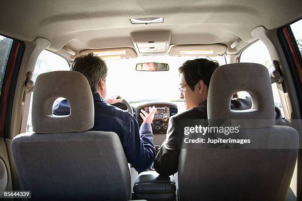 men driving in car together - fahrgemeinschaft stock-fotos und bilder