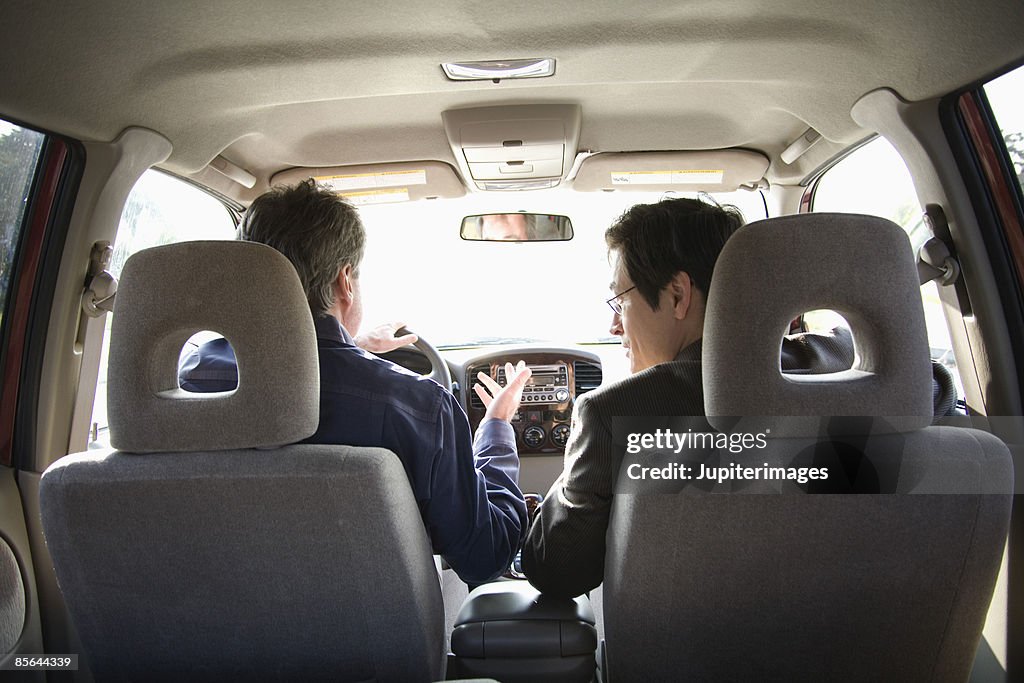 Men driving in car together