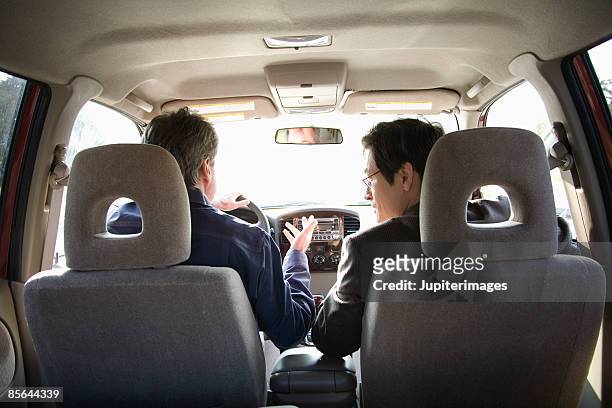 men driving in car together - mini van driving stock pictures, royalty-free photos & images