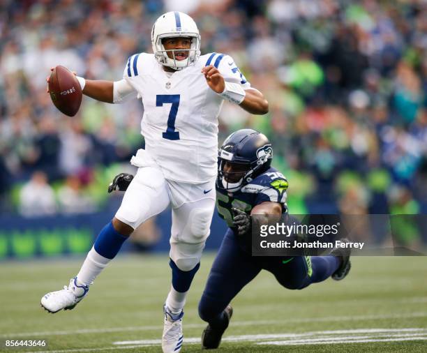 Jacoby Brissett of the Indianapolis Colts tries to escape defensive end Cliff Avril of the Seattle Seahawks in the first quarter at CenturyLink Field...