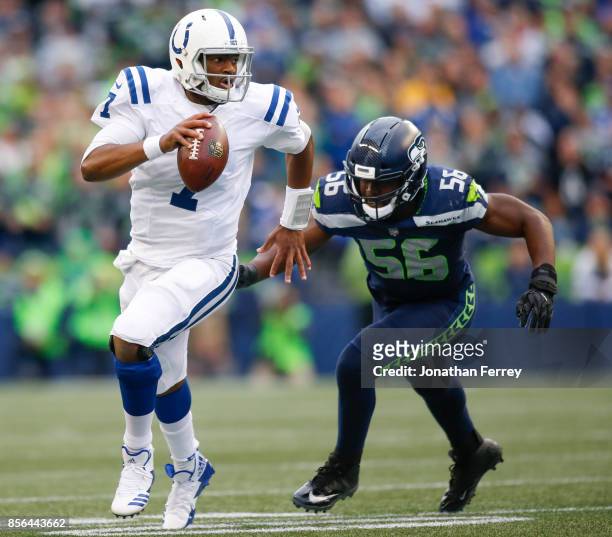 Jacoby Brissett of the Indianapolis Colts tries to escape defensive end Cliff Avril of the Seattle Seahawks in the first quarter at CenturyLink Field...