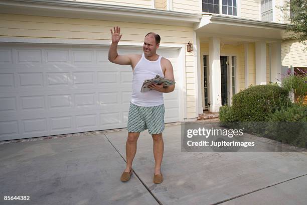 man waving outside of home - man in tank top stock pictures, royalty-free photos & images