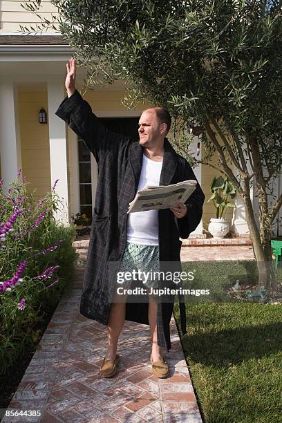 man waving outside of home - robe stock pictures, royalty-free photos & images