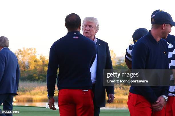 President of the United States Donald Trump talks with Tiger Woods after the Presidents Cup on October 1 at Liberty National Golf Club in Jersey City...