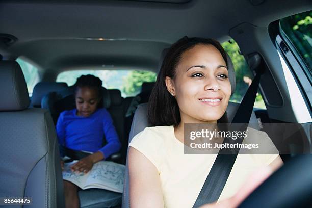 mother and daughter in car - young child car driving stock-fotos und bilder