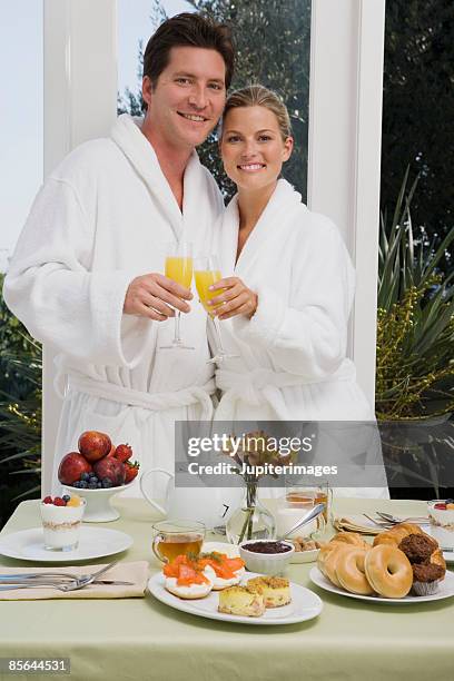 smiling couple with mimosas at breakfast - mini quiche stock pictures, royalty-free photos & images