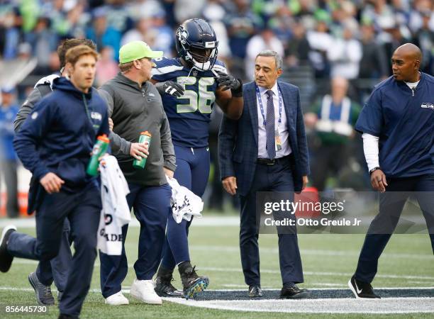 Defensive end Cliff Avril of the Seattle Seahawks walks off the field after being checked on by training staff in the first quarter of the game...