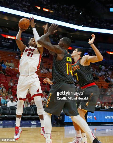 Miami Heat center Hassan Whiteside shoots over Atlanta Hawks forward Ersan Ilyasova and enter Dewayne Dedmon during the first quarter of an NBA...