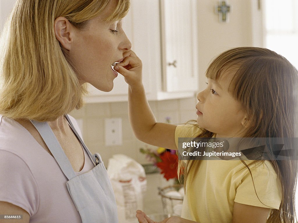 Girl feeding mother