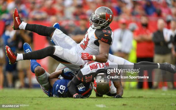 Tampa Bay Buccaneers linebacker Adarius Glanton and Tampa Bay Buccaneers cornerback Robert McClain tackle New York Giants wide receiver Sterling...