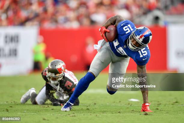 New York Giants wide receiver Brandon Marshall can't quite keep his balance after stepping through a tackle during an NFL football game between the...