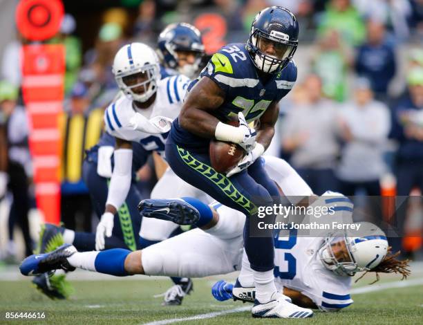 Running back Chris Carson of the Seattle Seahawks is tackled by Jabaal Sheard of the Indianapolis Colts in the first quarter of the game at...