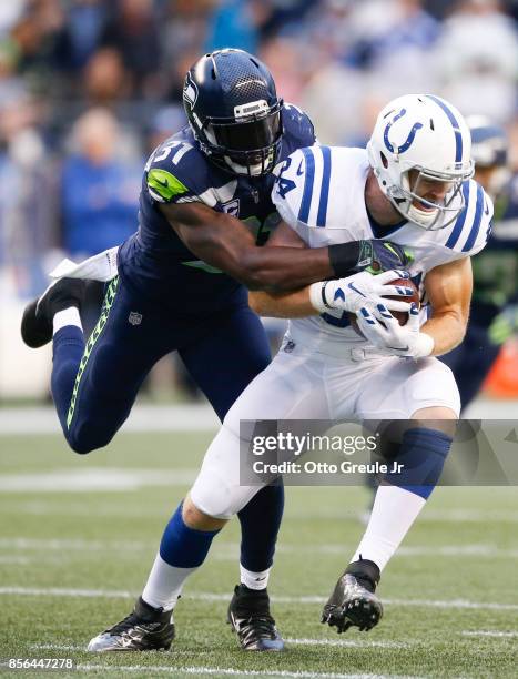 Tight end Jack Doyle of the Indianapolis Colts is tacked by strong safety Kam Chancellor of the Seattle Seahawks in the second quarter of the game at...