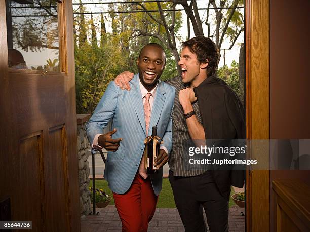 two men laughing - welcoming guests foto e immagini stock