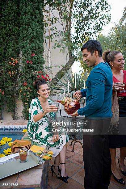 man pouring sangria for woman - sangria stock pictures, royalty-free photos & images