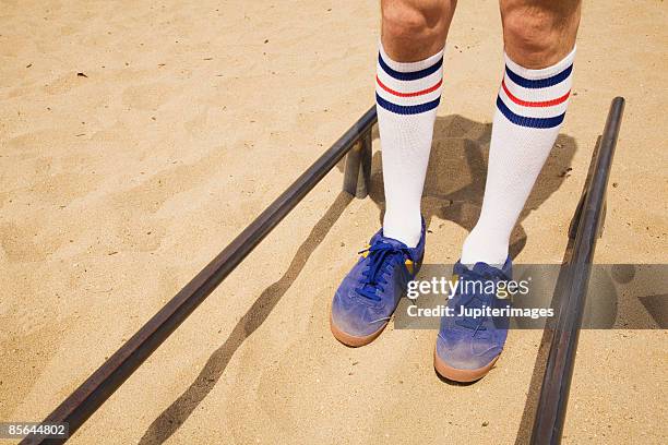man's legs with sneakers and striped socks - striped socks stock pictures, royalty-free photos & images