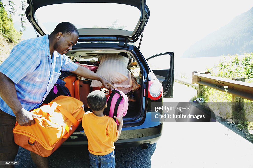 Father and son loading car