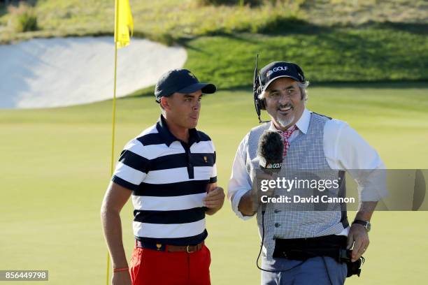 Rickie Fowler of the United States team talks to David Feherty after his win in his match against Emiliano Grillo of the International Team during...