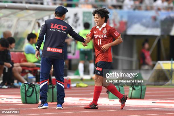 Hisato Sato of Nagoya Grampus shakes hand with Head coach Yahiro Kazama after substituted during the J.League J2 match between FC GIfu and Nagoya...