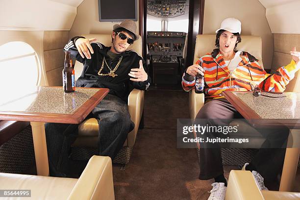 urban hipsters on private airplane - celebrity fake stock pictures, royalty-free photos & images