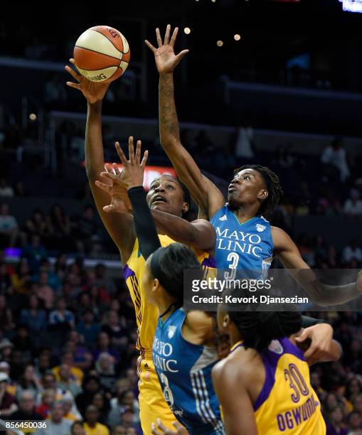 Jantel Lavender of the Los Angeles Sparks shoots under pressure from forward Natasha Howard and Maya Moore of the Minnesota Lynx during the second...