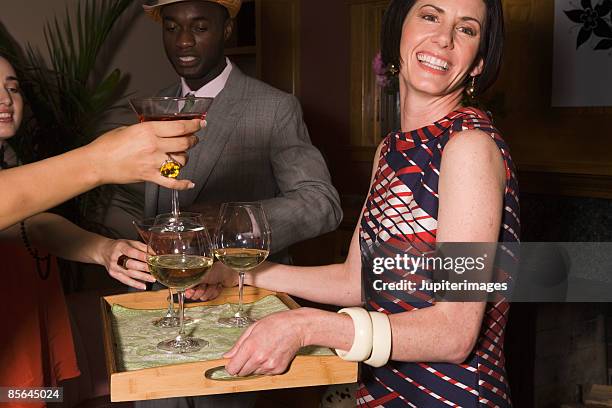 woman serving cocktails at party - party host foto e immagini stock