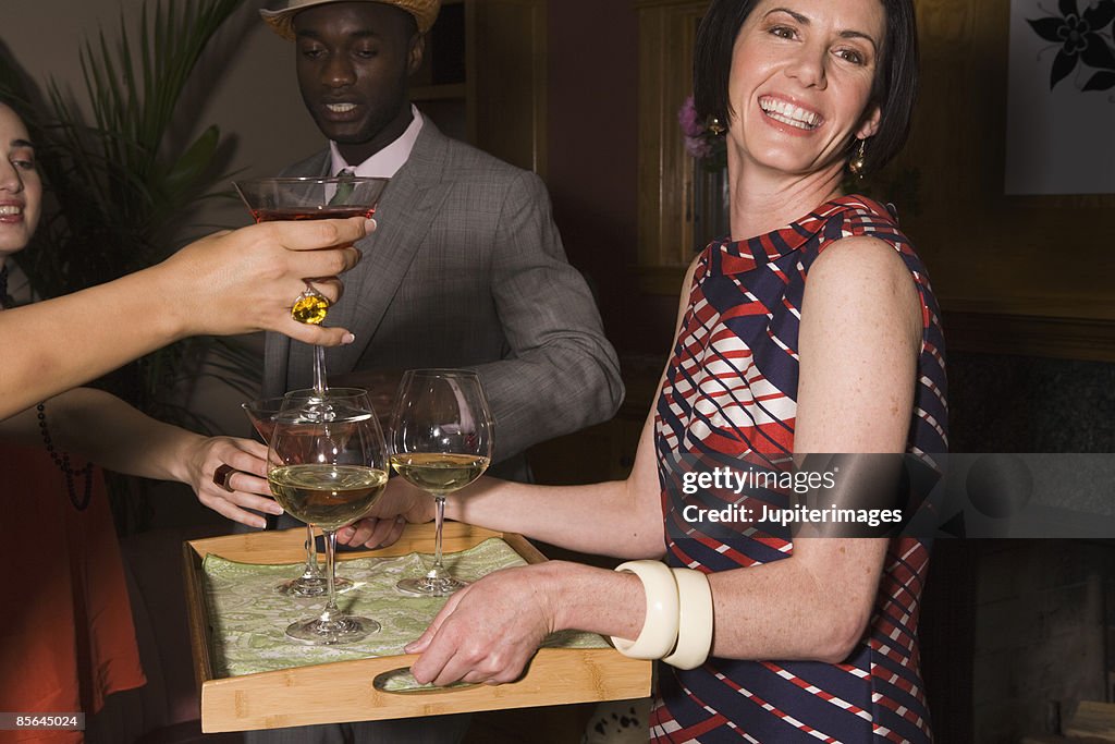 Woman serving cocktails at party