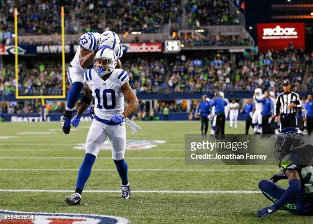 Running back Robert Turbin of the Indianapolis Colts celebrates the 18 yard touchdown by wide receiver Donte Moncrief against the Seattle Seahawks in...