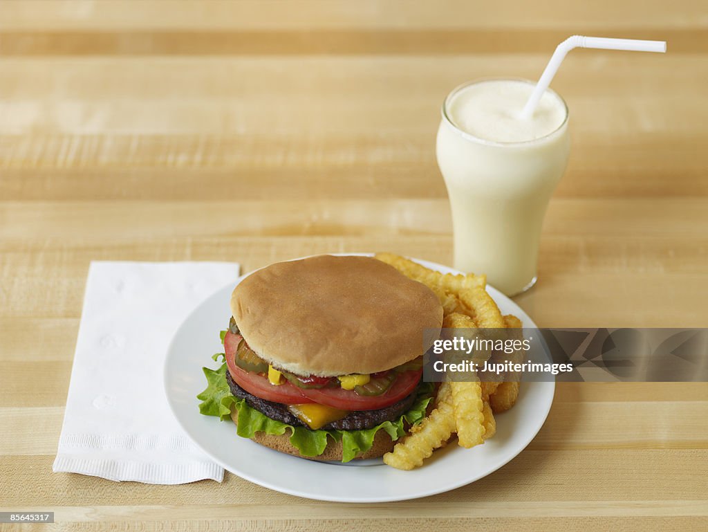 Cheeseburger , French fries , and vanilla milkshake
