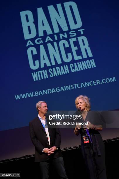 Of Tennessee Oncology Dr. Jeff Patton and CEO of Sarah Cannon Dee Anna Smith speak onstage during Band Against Cancer with Sarah Cannon on a special...