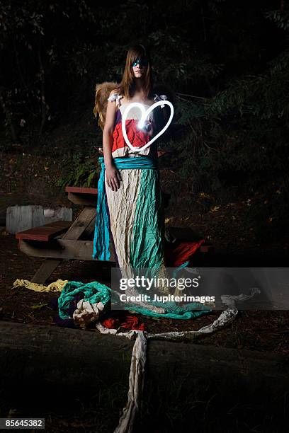 woman drawing heart with light - woodland fairy costume stock pictures, royalty-free photos & images