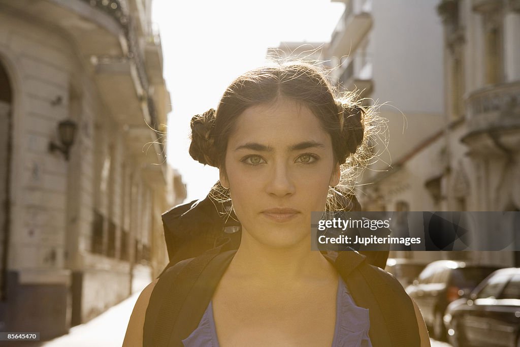 Portrait of woman with backpack in street