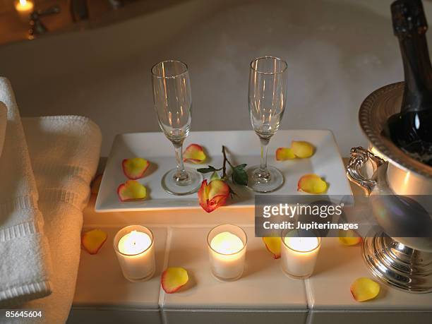 champagne and fruit for two - bubble bath bottle stock pictures, royalty-free photos & images