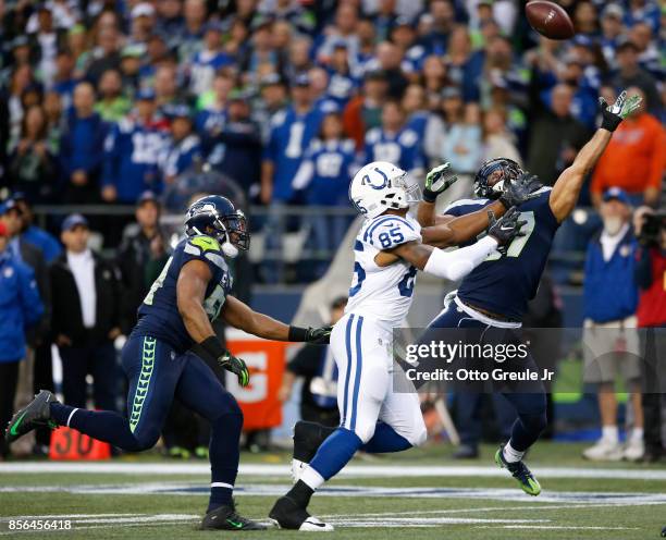 Linebacker Michael Wilhoite of the Seattle Seahawks reaches to tip away a pass to tight end Brandon Williams of the Indianapolis Colts in the end...