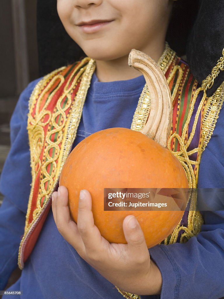 Boy holding pumpkin