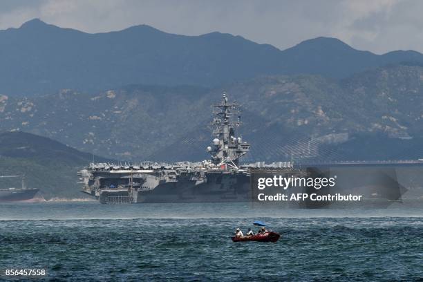 The US Navy's USS Ronald Reagan , a Nimitz-class nuclear-powered supercarrier, sails in Hong Kong waters on October 2, 2017. / AFP PHOTO / Anthony...