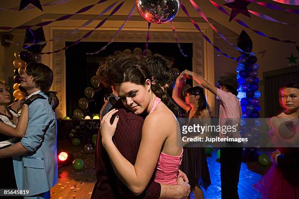 teenage couple dancing at prom - proms stock-fotos und bilder