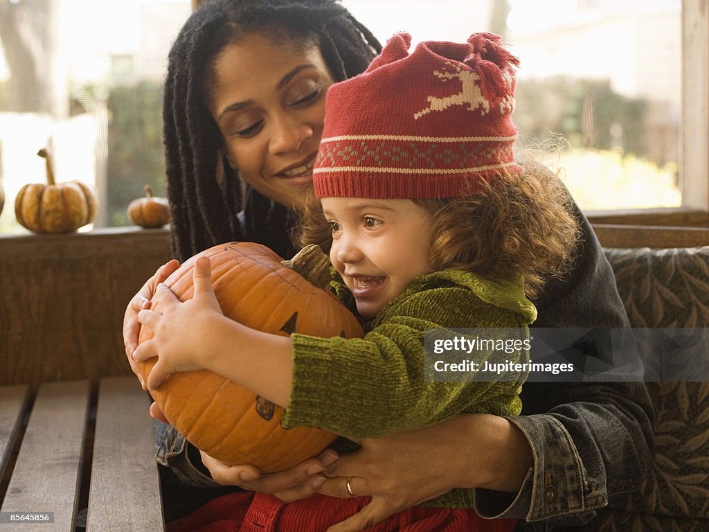 Mother and daughter with jack-o'-lantern