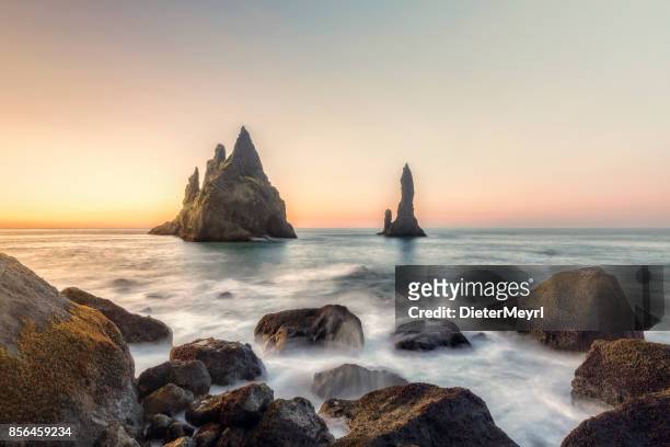 reynisdrangar cliffs on black sand beach, vik, iceland - vik stock pictures, royalty-free photos & images