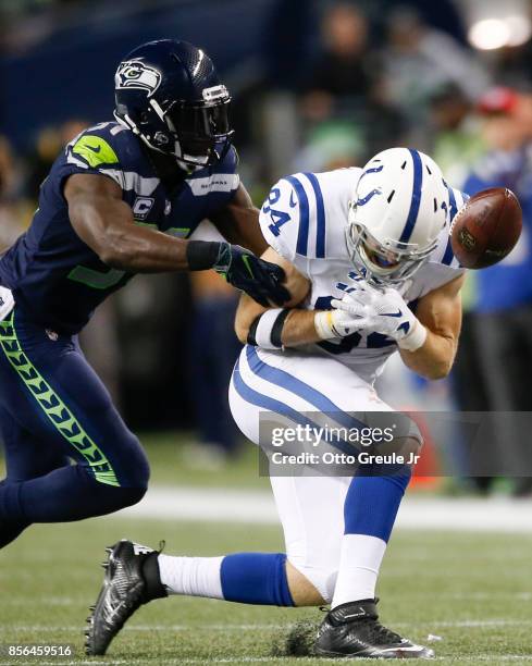 Strong safety Kam Chancellor of the Seattle Seahawks breaks up a pass to tight end Jack Doyle of the Indianapolis Colts in the second quarter of the...