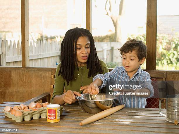 mother and son baking - crack spoon stock pictures, royalty-free photos & images