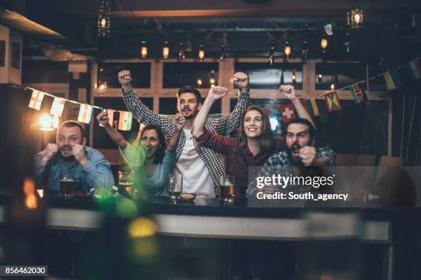 celebrating in the pub - soccer supporter stock pictures, royalty-free photos & images