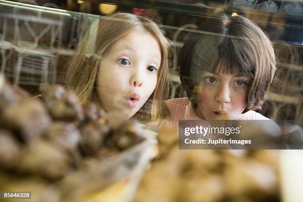 girls awed by candy behind counter - candy lips stock pictures, royalty-free photos & images