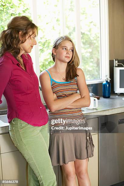 mother and daughter engaged in awkward conversation - ぎょろ目 ストックフォトと画像