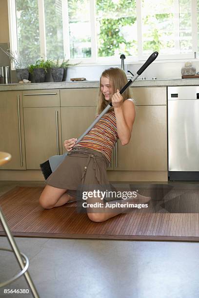 teenage girl playing in kitchen - air guitar stock pictures, royalty-free photos & images